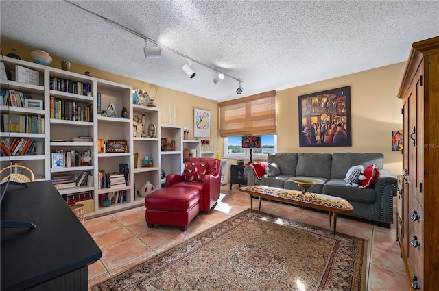 living room featuring track lighting, a textured ceiling, and light tile patterned floors