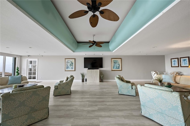 living room with a tray ceiling