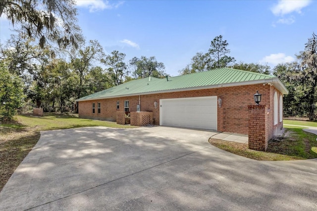 view of property exterior featuring a yard and a garage