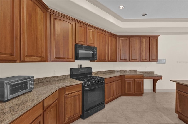 kitchen with light stone counters, light tile patterned floors, and black appliances