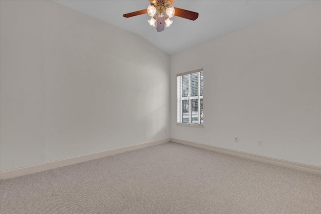 empty room featuring vaulted ceiling, carpet flooring, and ceiling fan