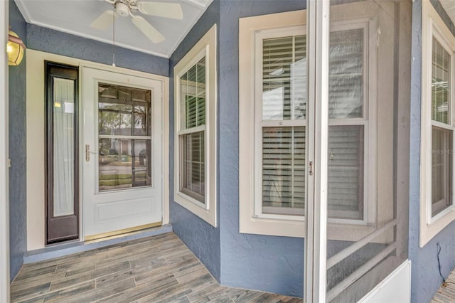 entrance to property featuring ceiling fan