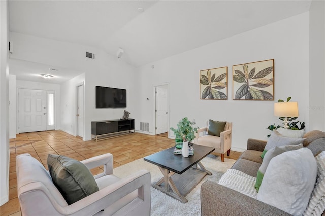 tiled living room featuring vaulted ceiling