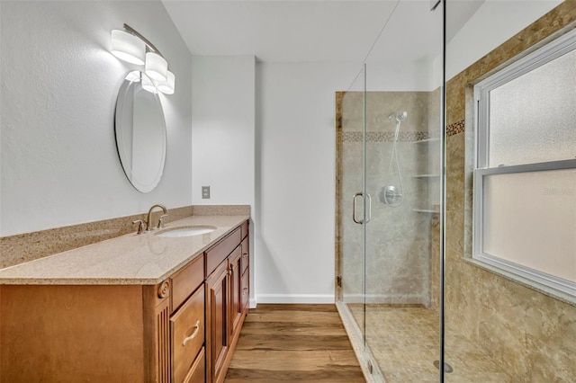 bathroom with vanity, hardwood / wood-style floors, and a shower with shower door