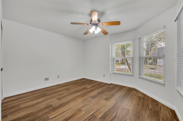 empty room featuring hardwood / wood-style flooring, ceiling fan, and a textured ceiling