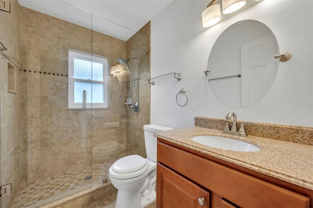 bathroom featuring vanity, walk in shower, and toilet