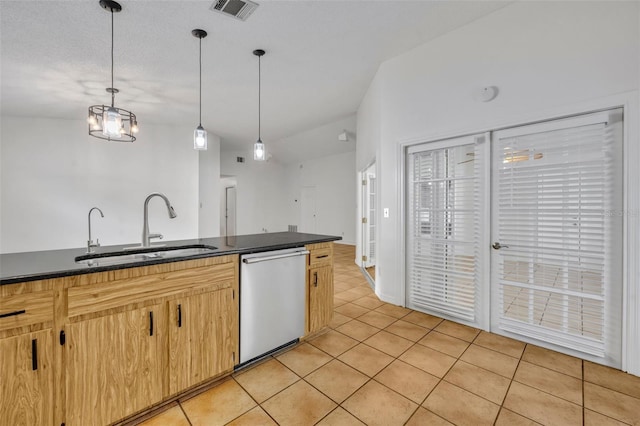 kitchen with lofted ceiling, sink, light tile patterned floors, dishwasher, and hanging light fixtures