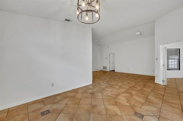 spare room featuring a chandelier and light tile patterned floors