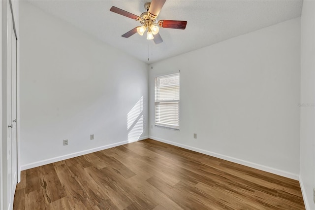 unfurnished room featuring hardwood / wood-style floors and ceiling fan