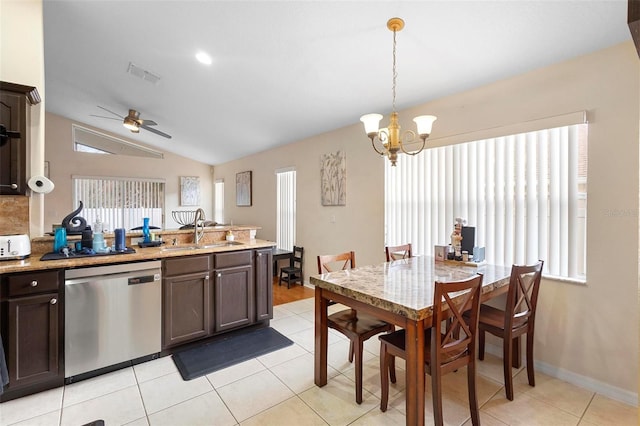 kitchen featuring lofted ceiling, decorative light fixtures, sink, stainless steel dishwasher, and dark brown cabinets