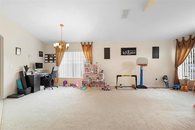 rec room with carpet floors and a notable chandelier