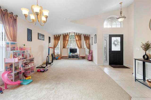 entryway with a chandelier and light tile patterned flooring