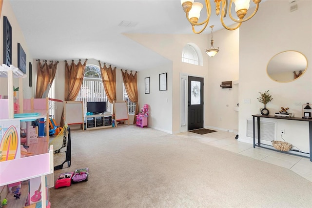 foyer entrance featuring light carpet and a notable chandelier