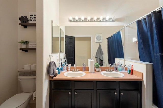 bathroom featuring curtained shower, toilet, and vanity