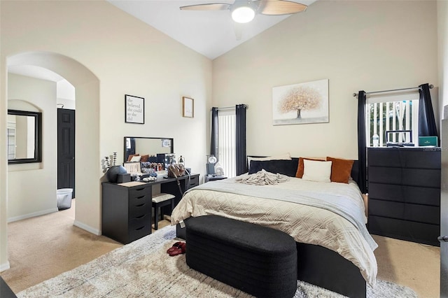 carpeted bedroom with high vaulted ceiling and ceiling fan