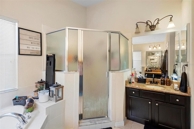 bathroom featuring independent shower and bath, tile patterned floors, and vanity