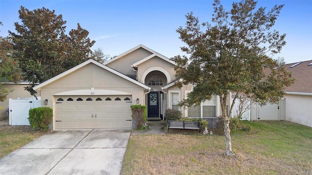 view of front of house featuring a garage and a front lawn