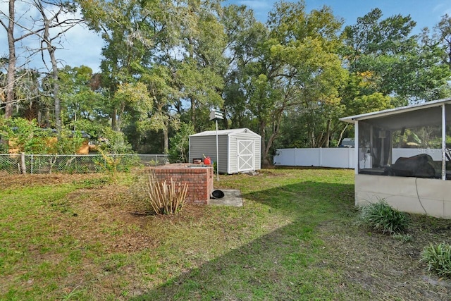 view of yard with a sunroom and a shed