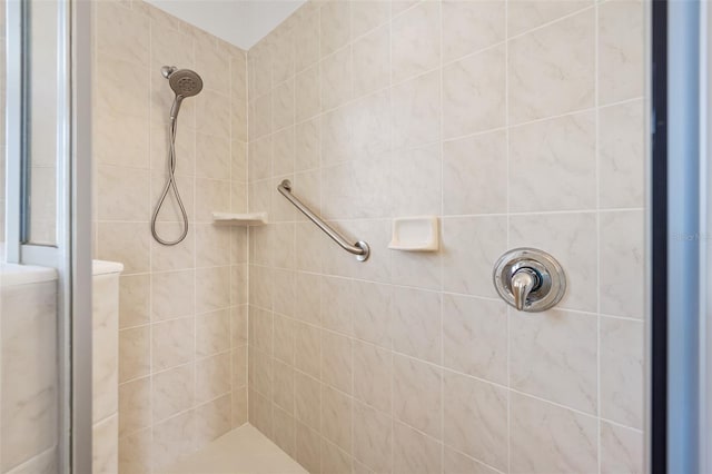 full bath featuring tiled shower