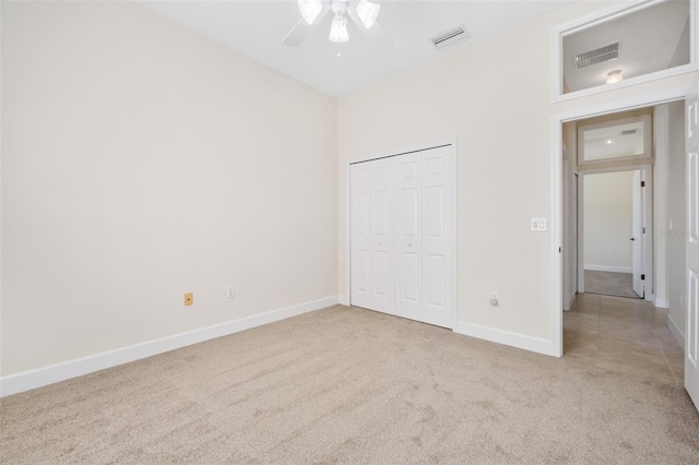 unfurnished bedroom featuring a closet, visible vents, baseboards, and carpet