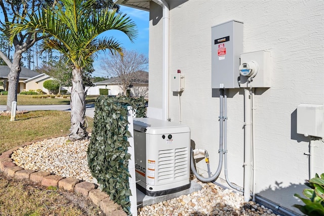 details with stucco siding, a power unit, and electric meter