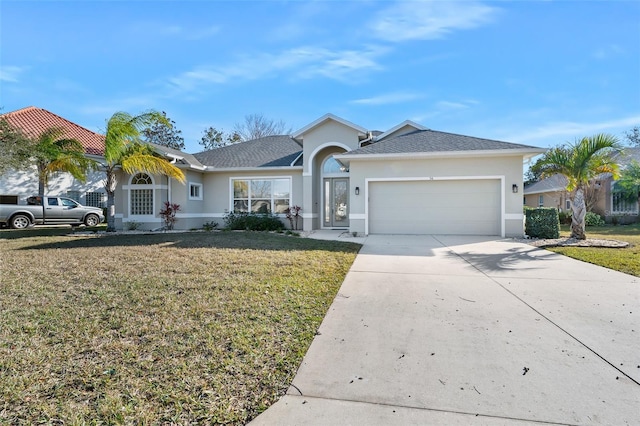 single story home with a front lawn, concrete driveway, a garage, and stucco siding