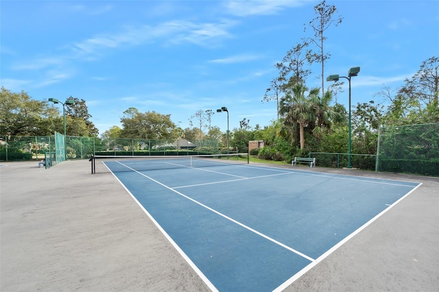 view of sport court with fence