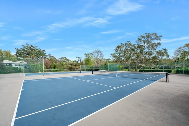 view of sport court featuring fence