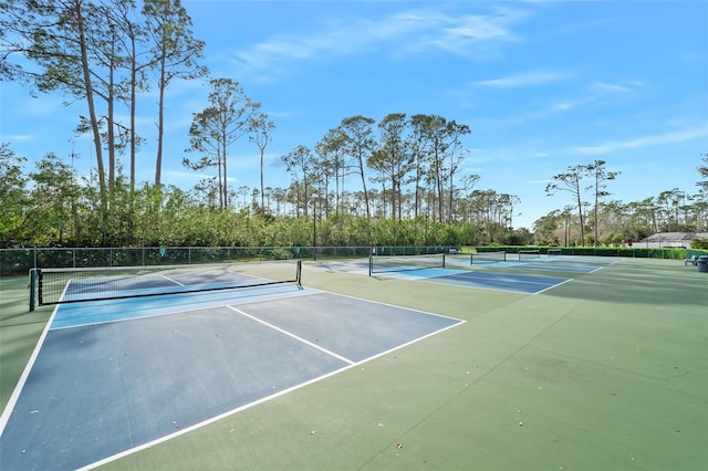 view of sport court featuring fence