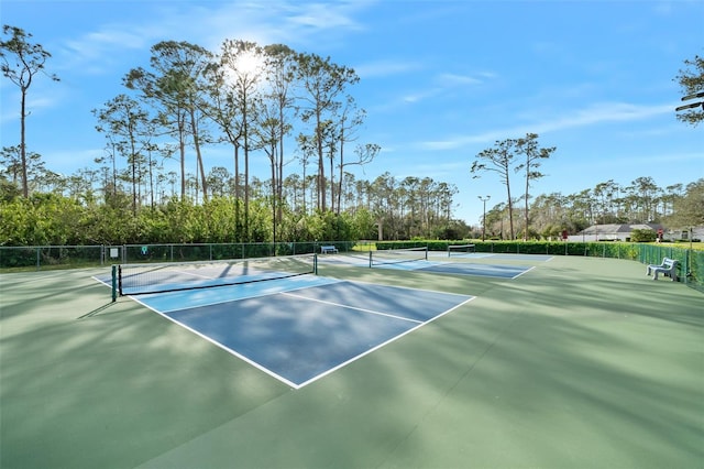 view of sport court featuring fence