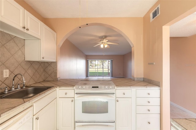 kitchen with ceiling fan, sink, white cabinets, tasteful backsplash, and white appliances