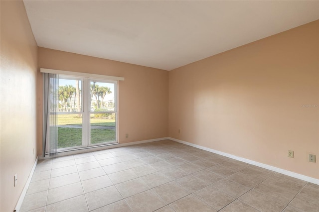 spare room featuring light tile patterned floors