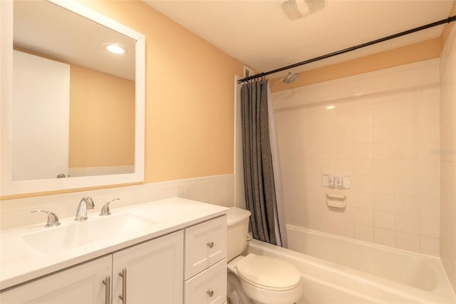 full bathroom featuring shower / bath combo with shower curtain, tile walls, toilet, and vanity