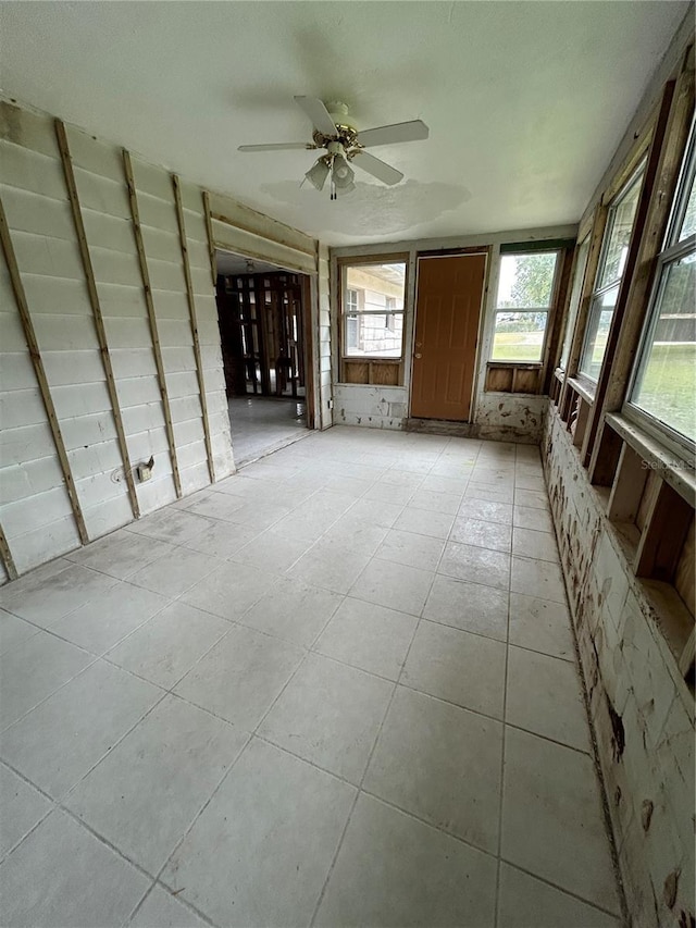 interior space with ceiling fan