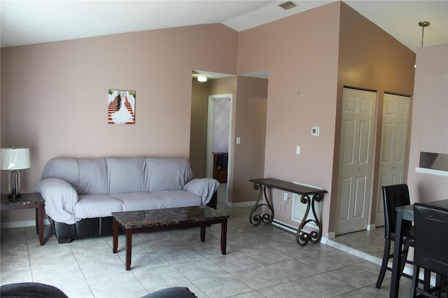 tiled living room featuring lofted ceiling