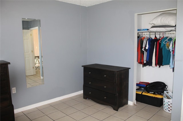 bedroom featuring a closet and light tile patterned floors