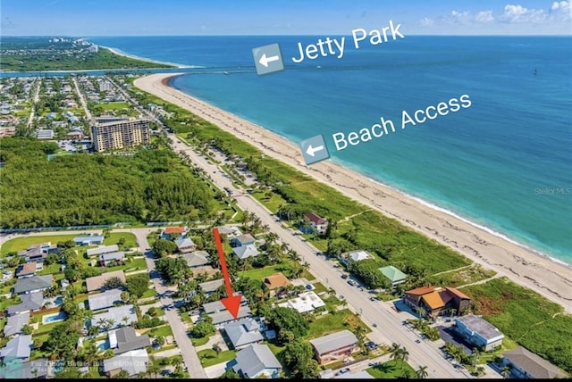 birds eye view of property with a view of the beach and a water view