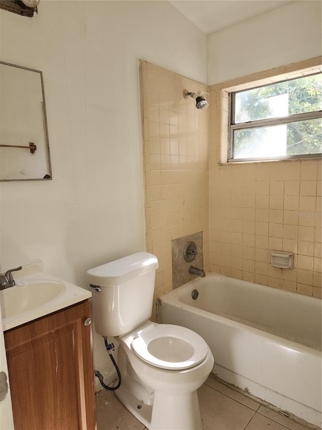 full bathroom with vanity, tiled shower / bath, tile patterned floors, and toilet