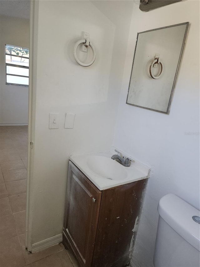 bathroom with vanity, tile patterned floors, and toilet