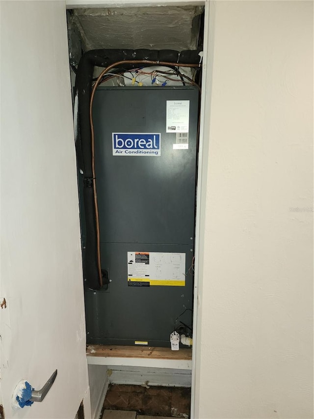 utility room featuring heating unit