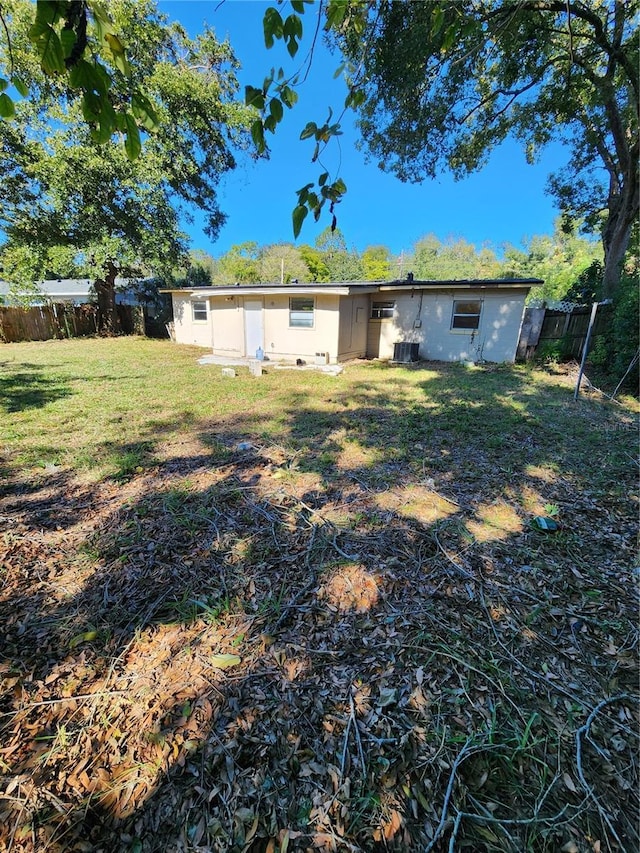 rear view of house featuring a lawn