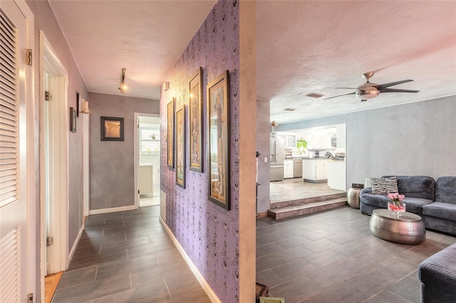 corridor featuring a textured ceiling