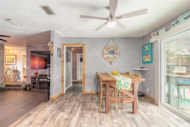 dining area with hardwood / wood-style flooring and ceiling fan