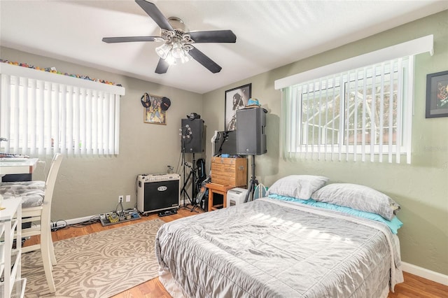 bedroom with light hardwood / wood-style flooring and ceiling fan