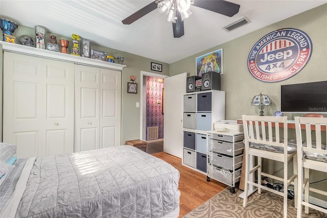 bedroom featuring hardwood / wood-style floors, a closet, and ceiling fan