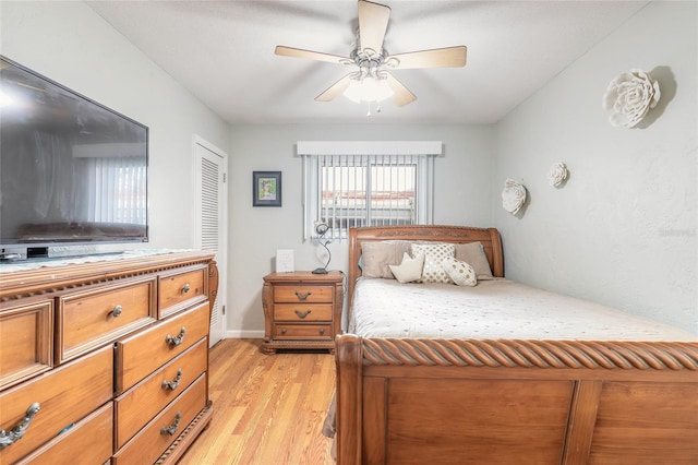 bedroom with a closet, ceiling fan, and light hardwood / wood-style floors