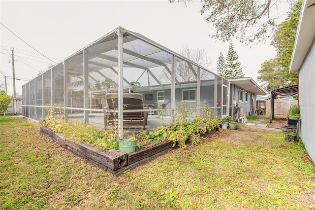 rear view of property featuring a swimming pool, a lanai, and a yard