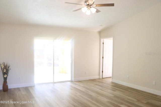 unfurnished room featuring ceiling fan, light wood-type flooring, lofted ceiling, and a wealth of natural light