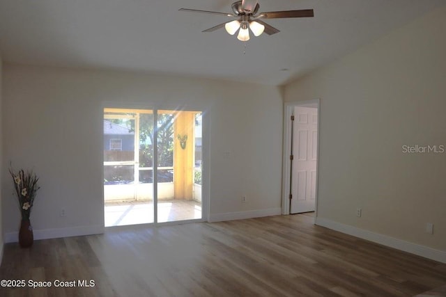 empty room with hardwood / wood-style floors, vaulted ceiling, and ceiling fan