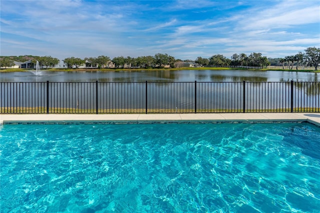 view of swimming pool with a water view